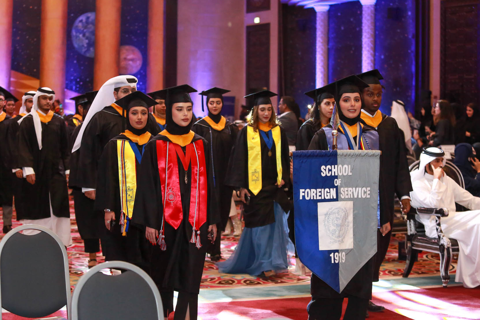 Students taking the ceremonial walk for graduation
